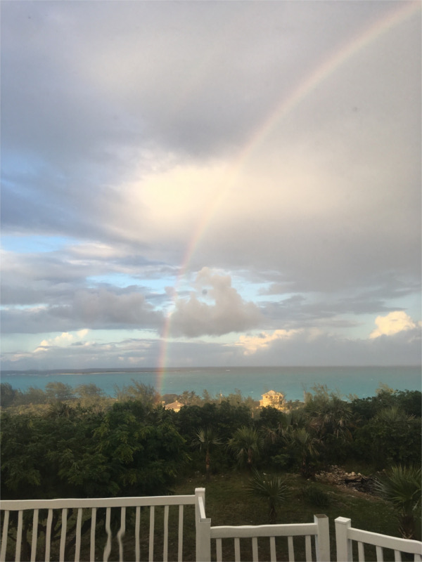 Rainbow and stunning clouds over ocean in Bahamas, looking from deck of rental house