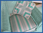 Soft green and gray patterned fabric on soft green color wicker chair