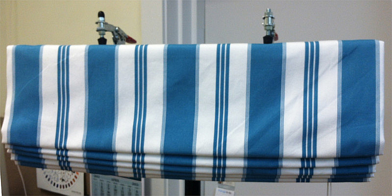 Relaxed Roman shade in blue and white striped fabric