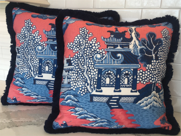 Square throw pillows with Chinese design in red and dark blue with soft furry black edging