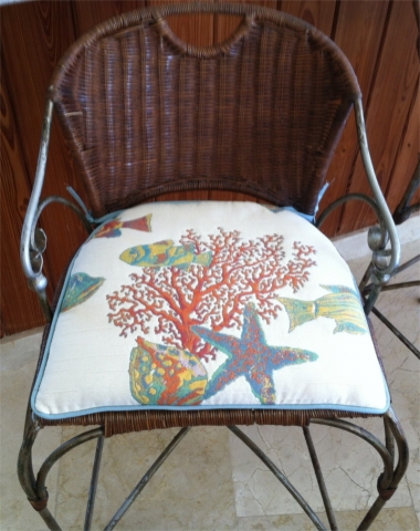 Custom hand-sewn perfectly-fitted cushion of underwater sea scene fabric on metal and wicker chair