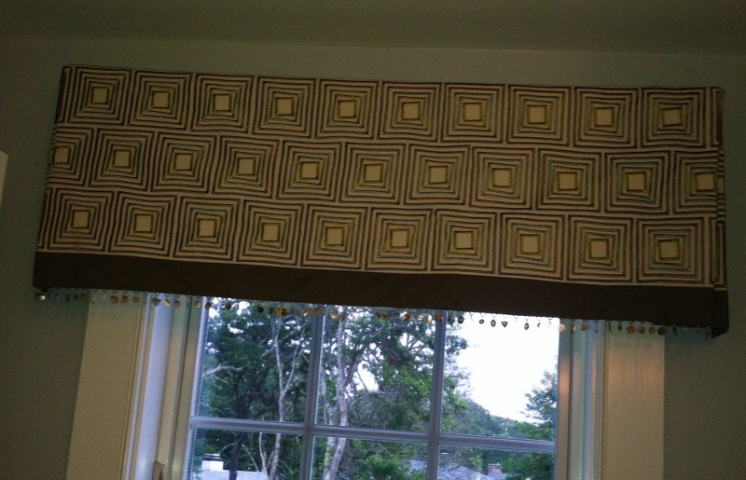 Valance of geometric pattern with solid color border and fringe below