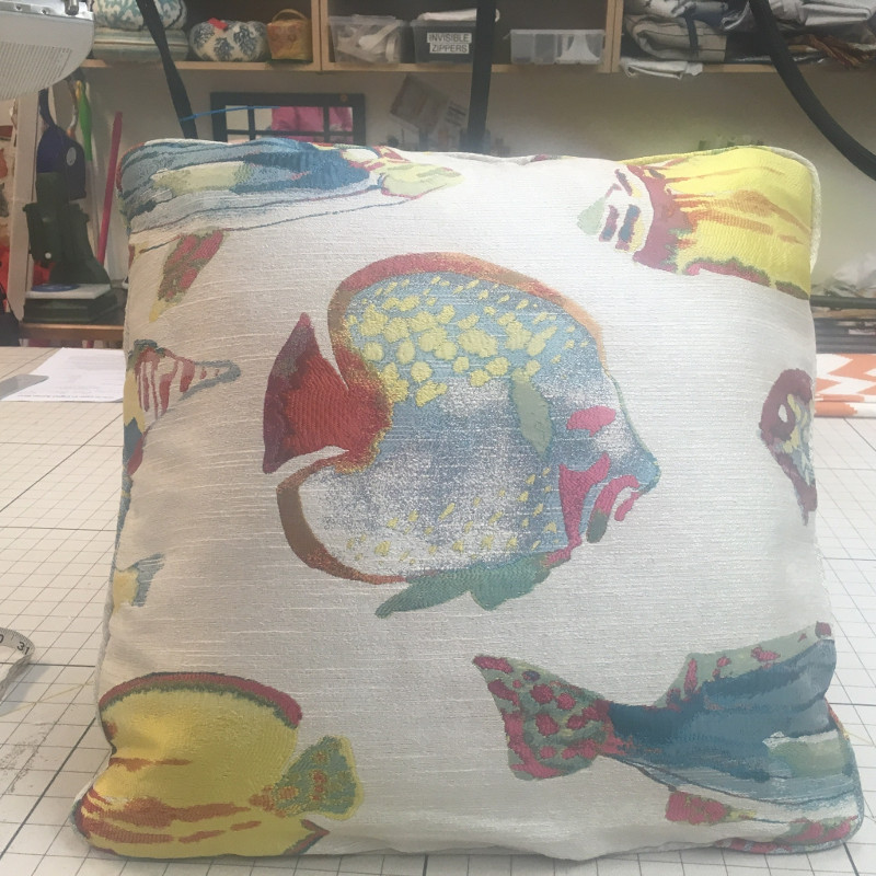 Throw pillow with tropical fish pattern and matching piping