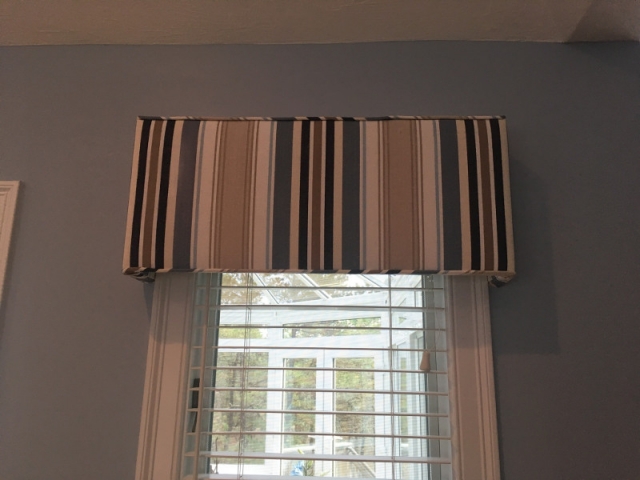 Valance drapes with piping installed on window
