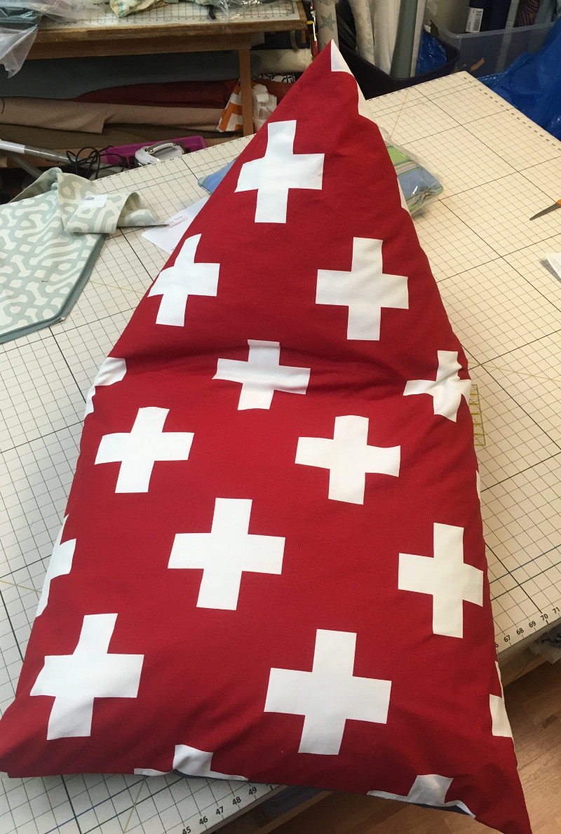 Uniquely shaped pillow, red with white crosses