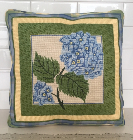 Embroidered hydrangea as pillow face with layers of different colored fabric as border