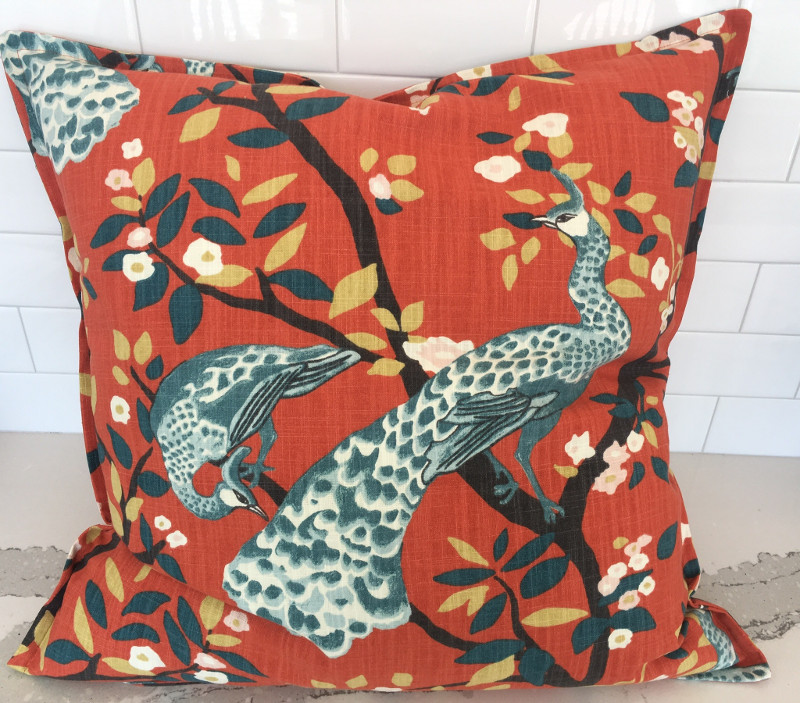 Patterned square throw pillow with stitched border