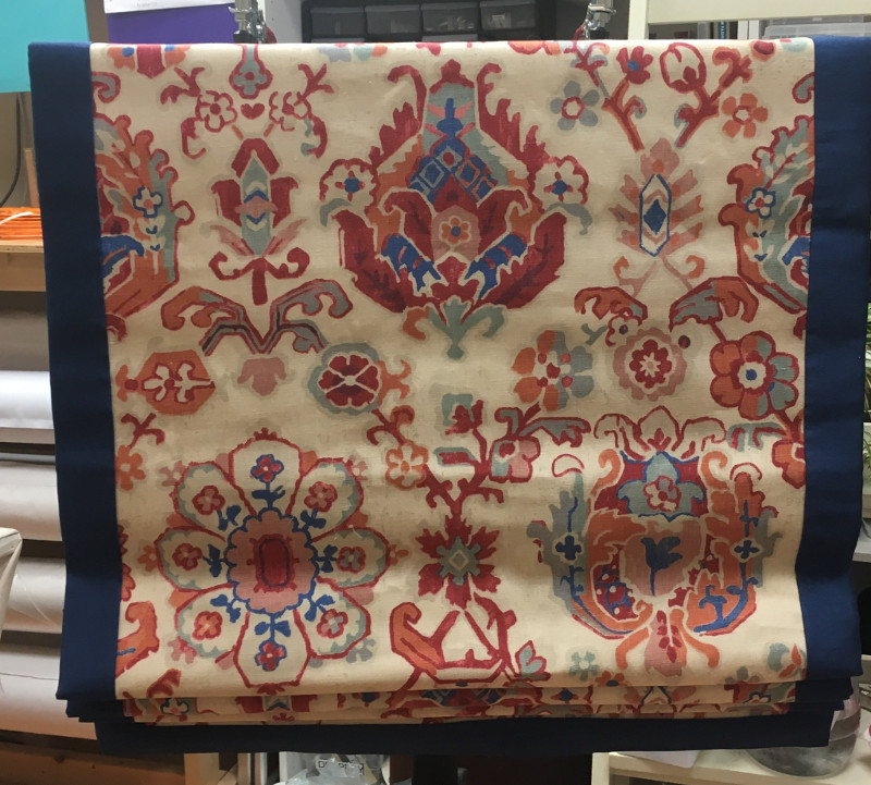 Roman shade of print fabric with blue border