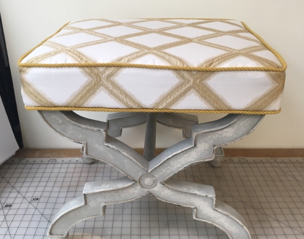 Rectangular seat cushion with gold piping and fabric pieces perfectly aligned