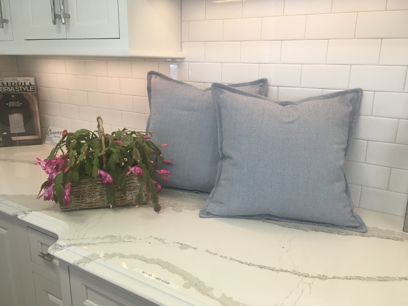 Square slate gray throw pillows with piping around edges