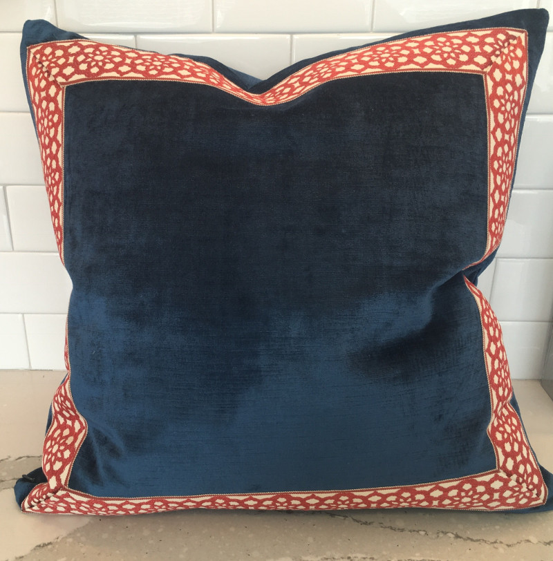 Square throw pillow with contrasting border on front panel