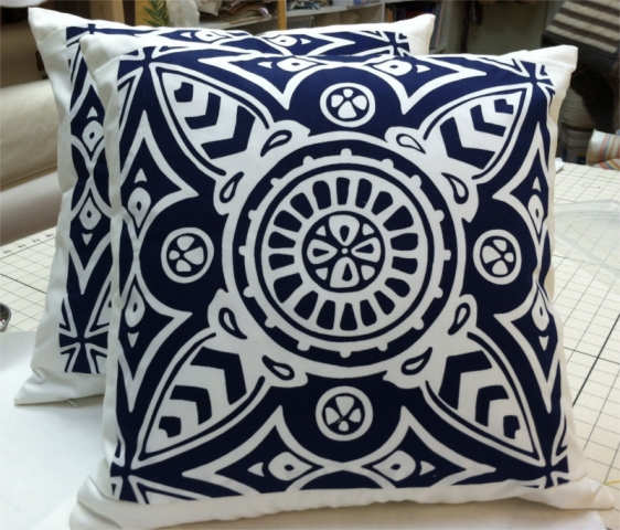 Navy blue patterned fabric squares perfectly positioned as covers on square pillows