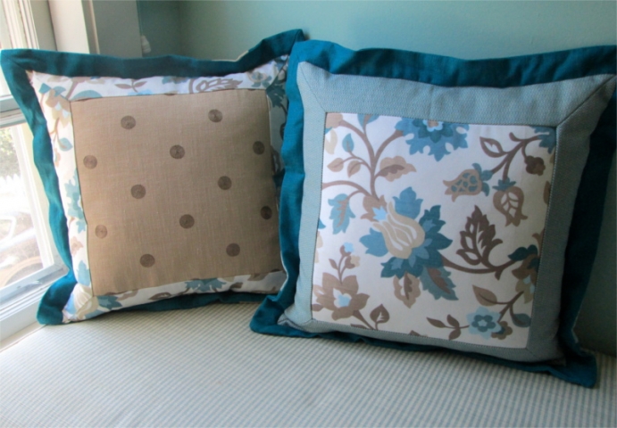 Throw pillows with multiple panels of fabrics and stitched edges