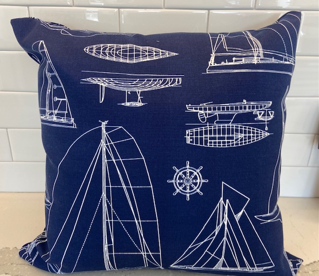 Drawings of boats and nautical items on a pillow