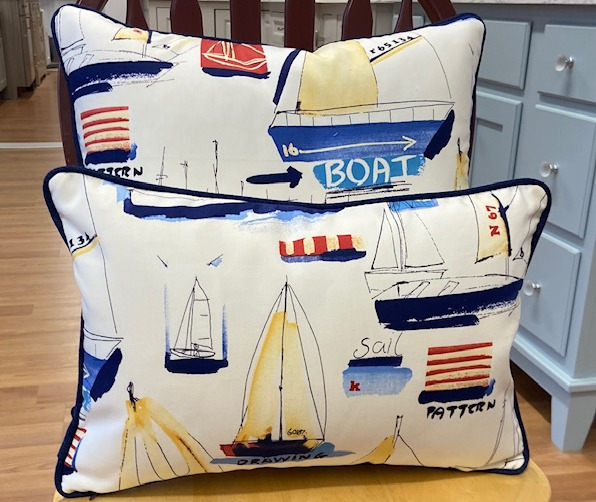 Throw pillows with a variety of sailboats on them